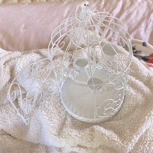 White bird cage with small candle holders